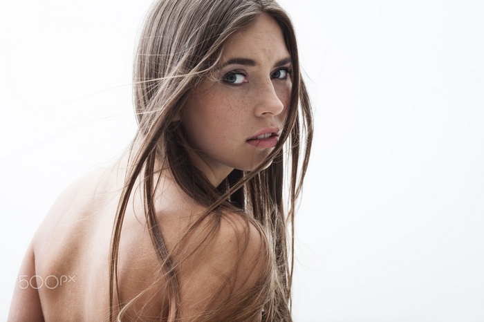 Woman with freckles and long brown hair