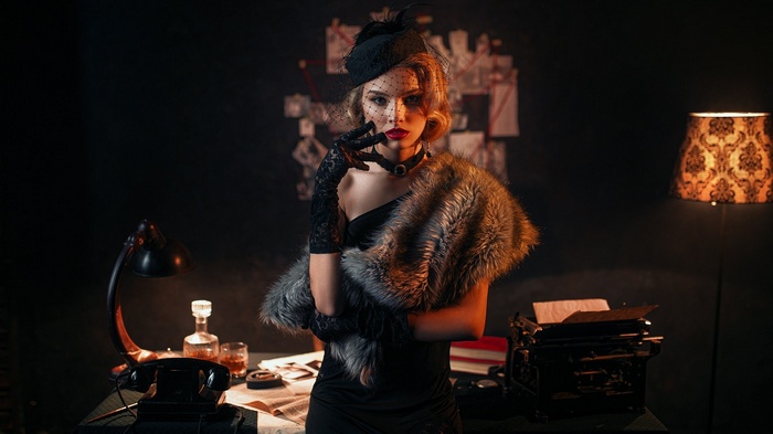 Woman in vintage attire with fur stole and hat