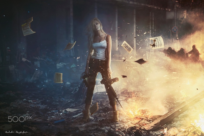 Woman with rifle in a destroyed urban environment