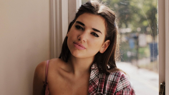 Dua Lipa by a window