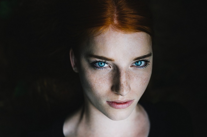 Redhead woman with blue eyes and freckles