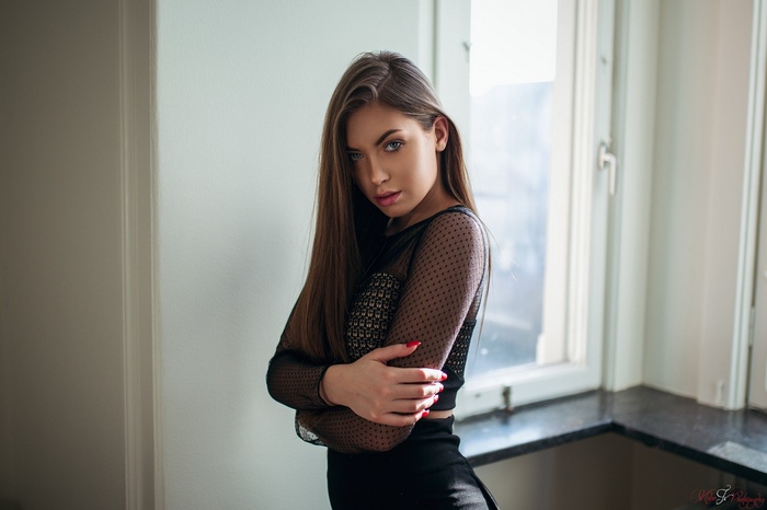 Woman in black clothing with red nails