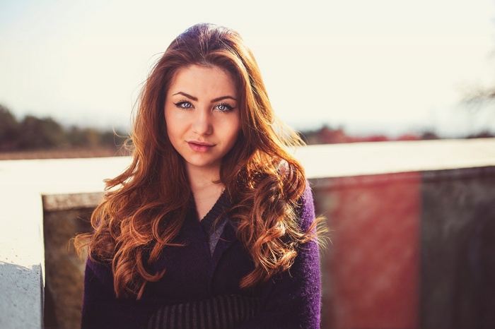 Woman with long auburn hair outdoors