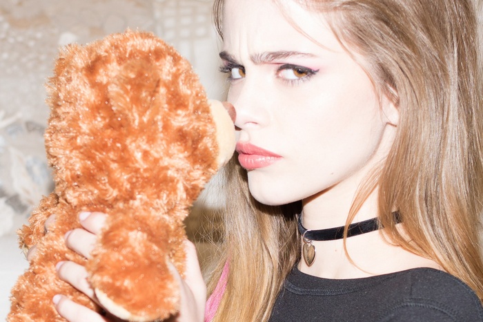 Woman with teddy bear and choker necklace