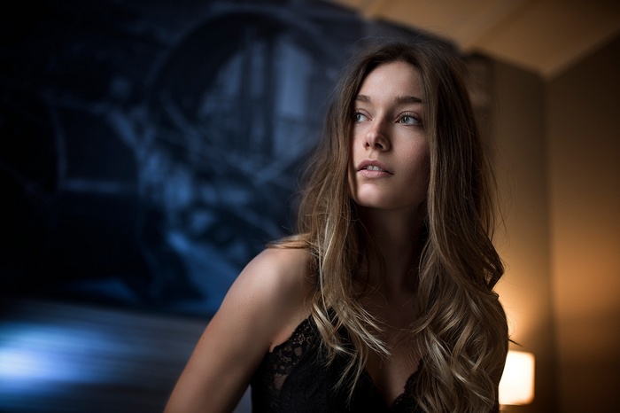 Woman with long brown hair looking away