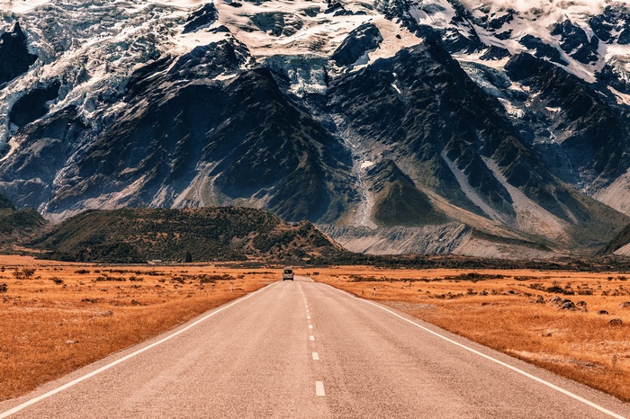 Road leading to snow-capped mountains