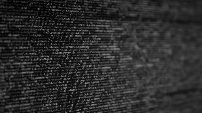 Blurred computer code on a dark background