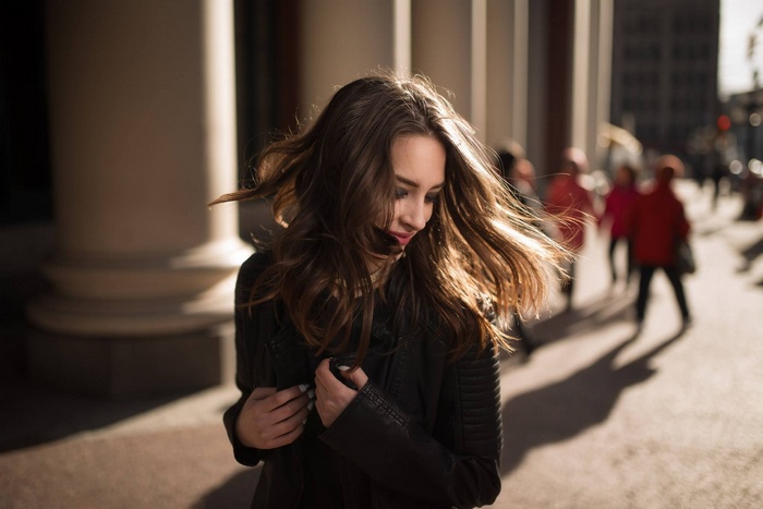 Woman with windblown hair in urban setting
