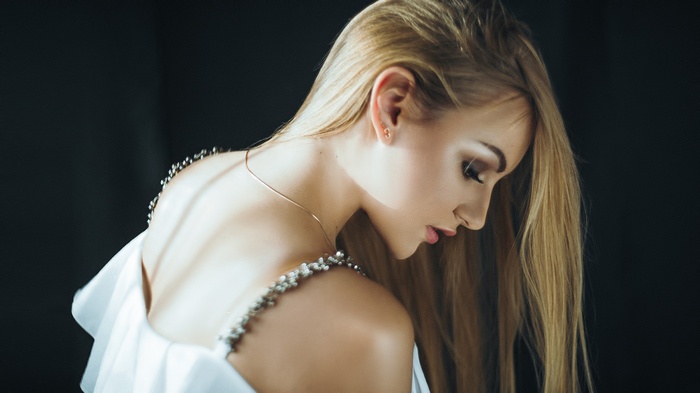 Woman with blonde hair wearing a white dress