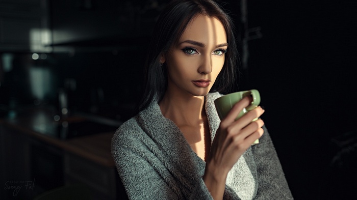 Kseniya Alekseevskaya holding a mug in a bathrobe