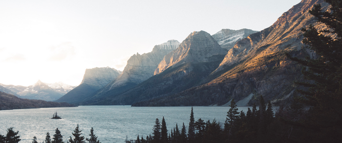Lake and mountains with snow at sunset
