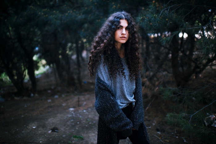 Woman with curly hair in a forest