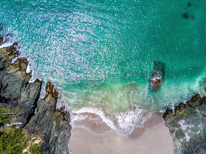 Aerial view of a rocky coastline and turquoise sea