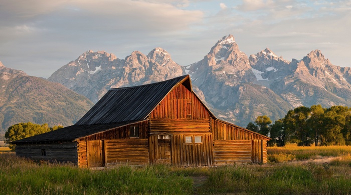 Wooden barn in front of the Teton Mountains