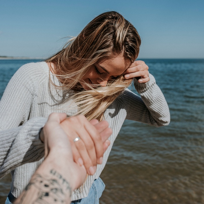 Couple holding hands by the water