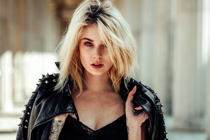 Woman with blonde hair wearing a spiked leather jacket