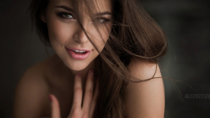 Woman with brown hair and open mouth