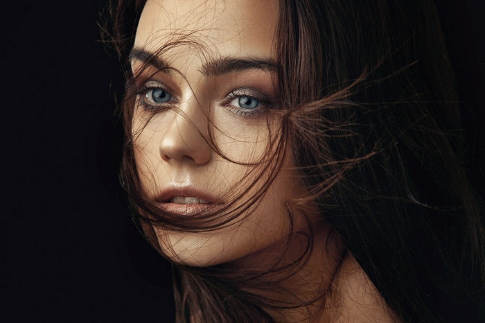 Woman with blue eyes and hair in face