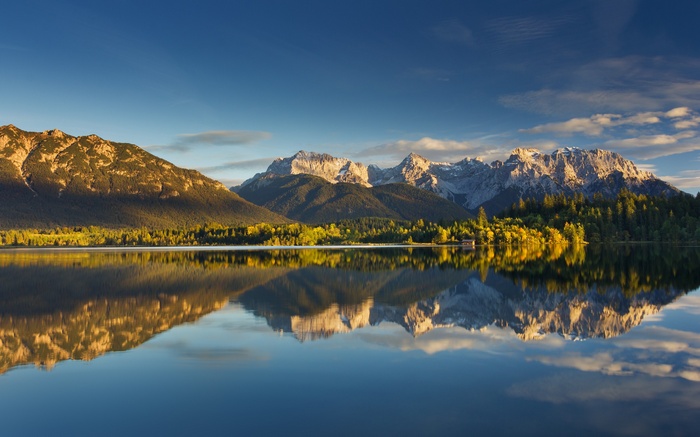 Mountains reflected in a calm lake at sunrise