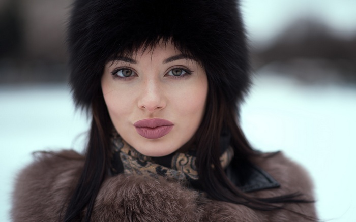 Woman in fur hat and coat outdoors