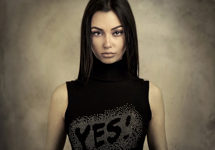 Woman in black turtleneck with 'YES!' shirt