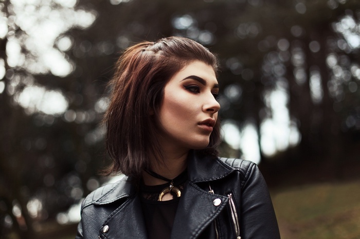Woman with short brown hair wearing a leather jacket