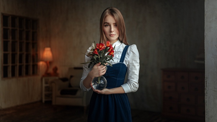 Woman holding a bouquet of flowers in a room