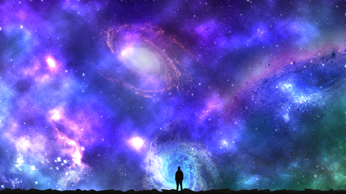 Silhouette of a person looking at a colorful galaxy
