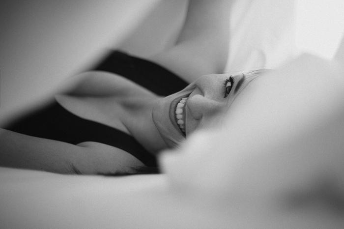 Woman smiling in bed