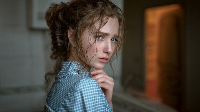 Portrait of a young woman with freckles