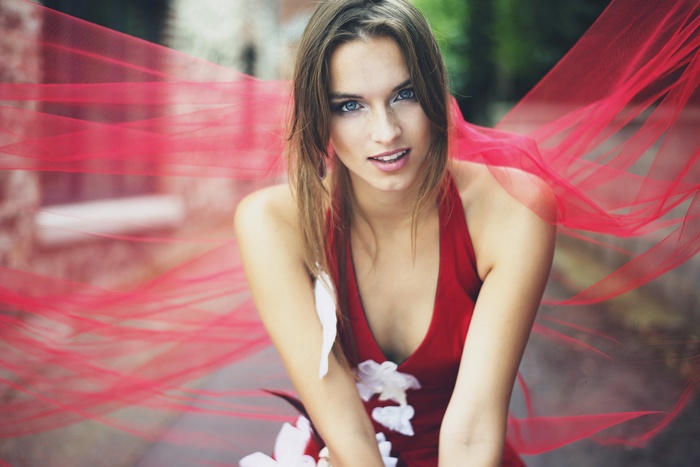 Woman in red dress with red veil outdoors