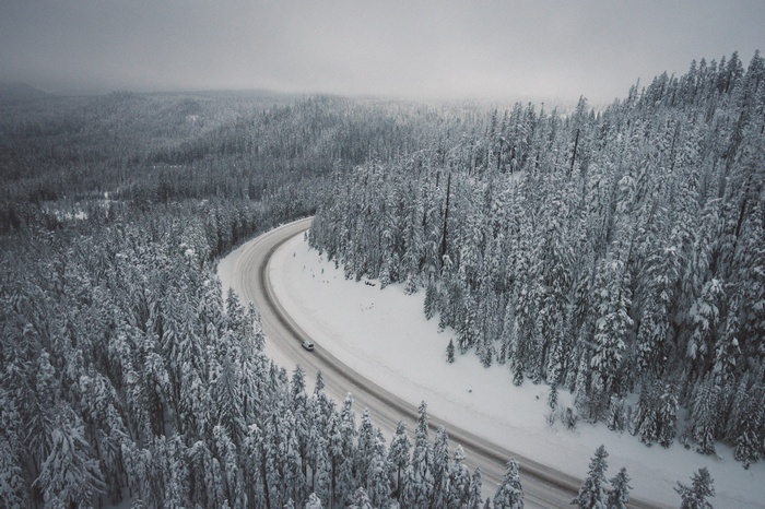 Aerial view of a car on a snowy road in Oregon