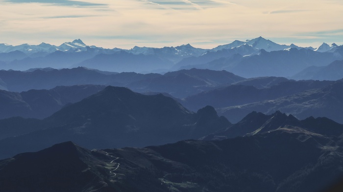 Layered mountain ranges under a hazy sky