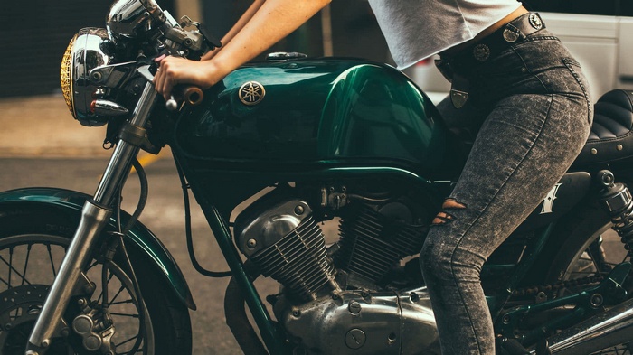 Woman on a green Yamaha motorcycle