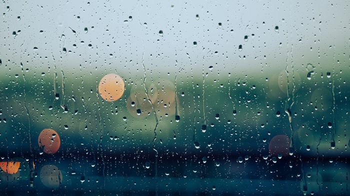 Raindrops on a window with bokeh lights