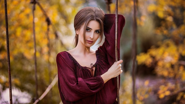 Woman with auburn hair in a burgundy dress