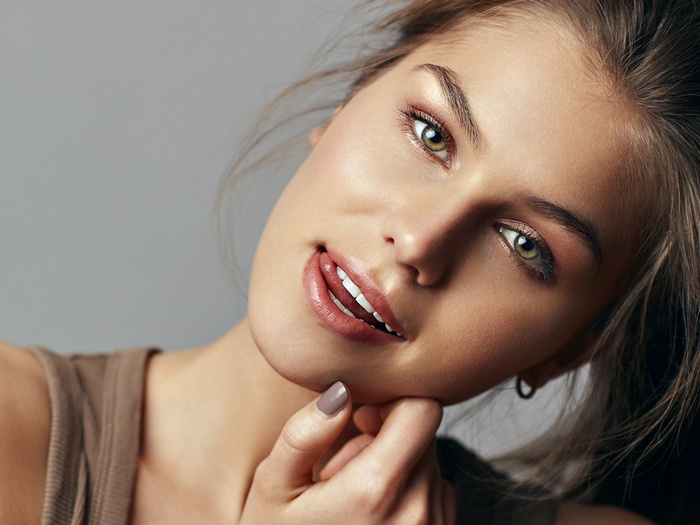 Woman with green eyes and tongue out