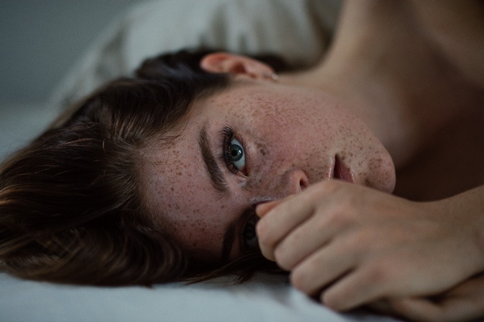 Chloe Bechtol with freckles lying down