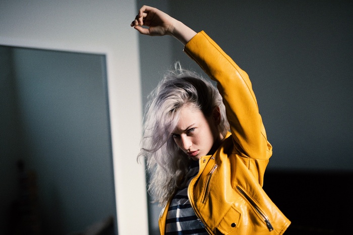 Woman in yellow jacket with purple hair