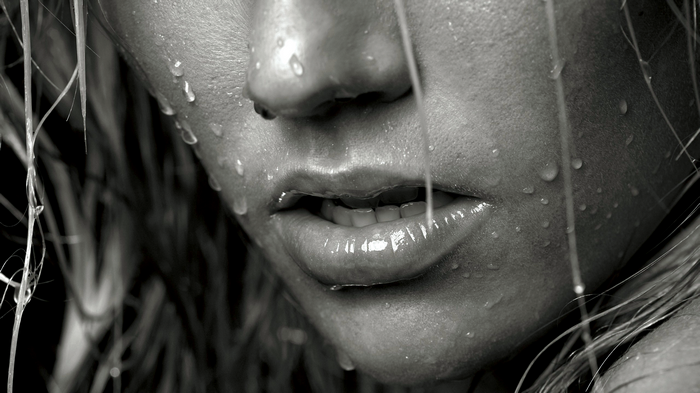 Close-up of a wet face with water drops