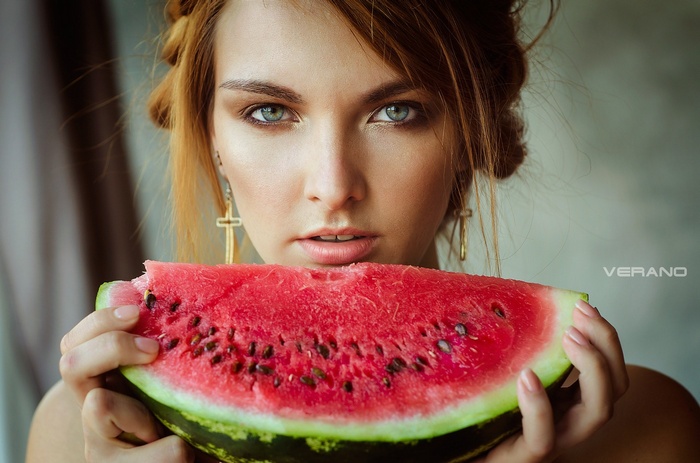 Woman holding a slice of watermelon