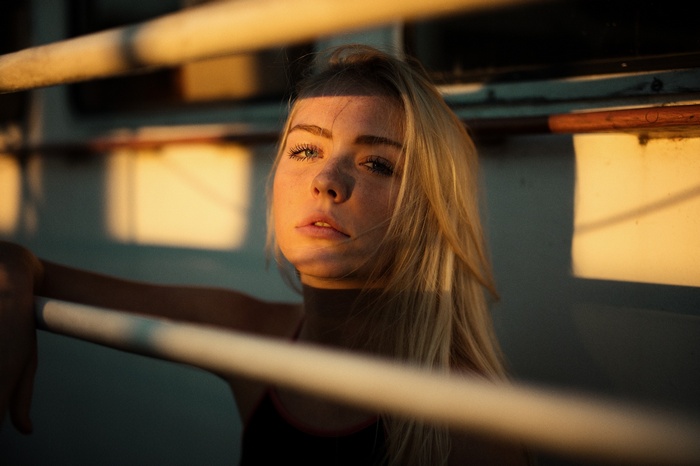 Woman with freckles and blonde hair in sunlight