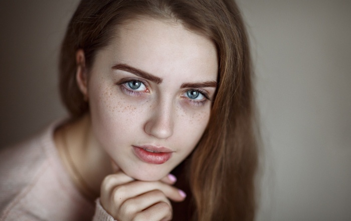 Portrait of a young woman with freckles
