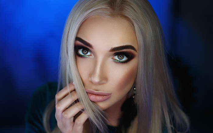 Woman with blonde hair and dramatic makeup