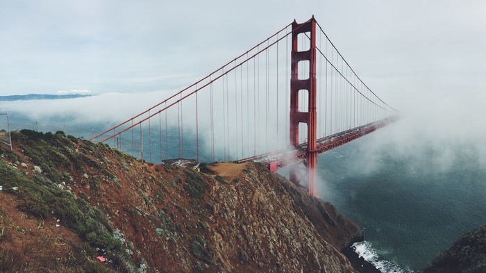 Golden Gate Bridge shrouded in fog over the sea