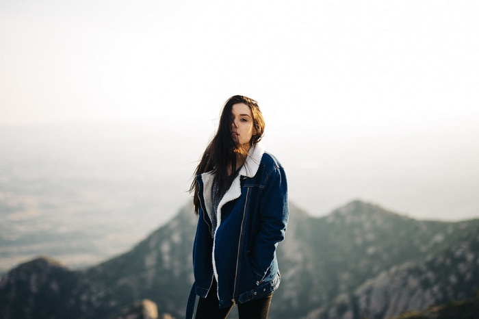 Woman in denim jacket on mountain top