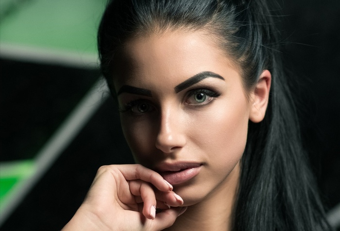 Woman with black hair and green eyes