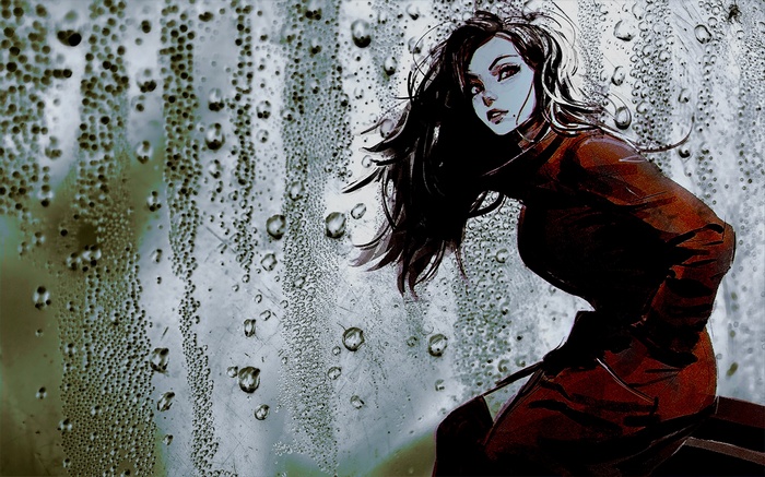 Woman in red jacket behind a wet window