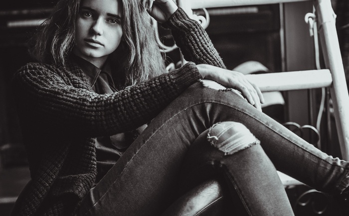 Woman in torn jeans and sweater
