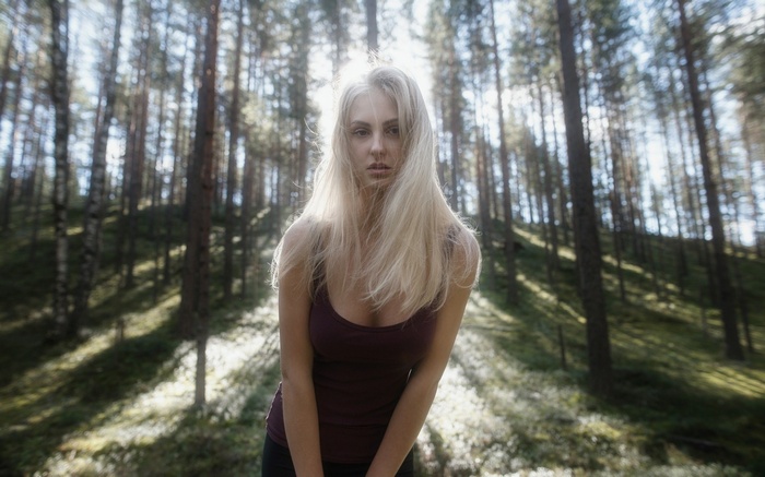 Tatiana Mertsalova in a forest with sunlight